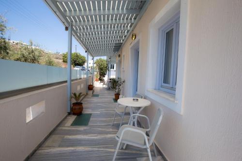a balcony with a table and chairs on a building at Erato Apartments in Firostefani