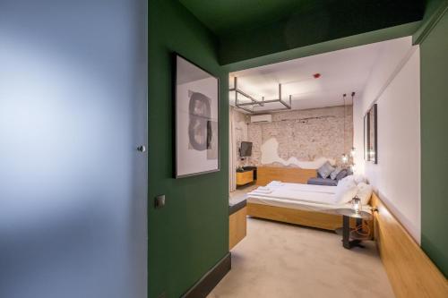 a room with a bed and a green wall at R34 Boutique Hotel in Sofia