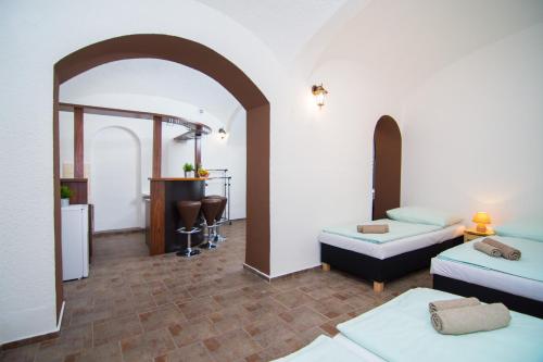 a living room with two beds and an archway at Penzion Anareta in Frýdek-Místek