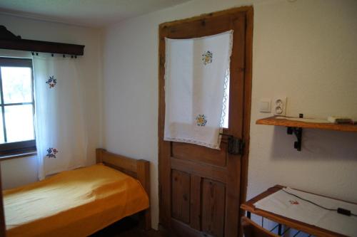 a bedroom with a bed and an open door at Guest House Glogovac in Kamenica