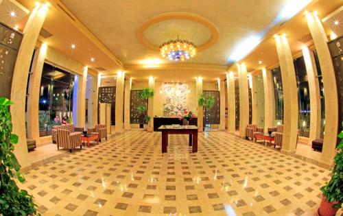 a lobby with a table and chairs and a chandelier at Sharm Club Beach Resort in Sharm El Sheikh