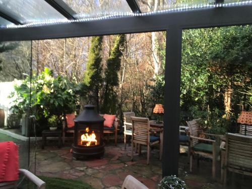 a patio with a fireplace and a table and chairs at JustB Edinburgh in Edinburgh