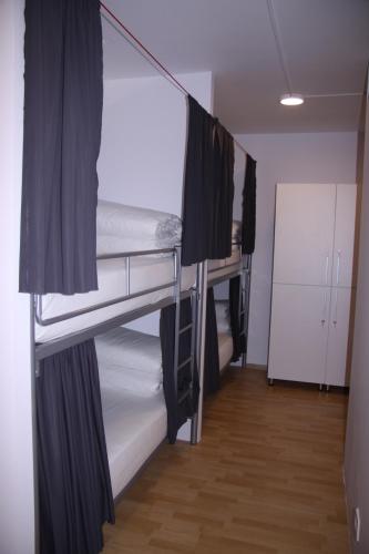 a room with three bunk beds in a room at ART Hostel in Tirana