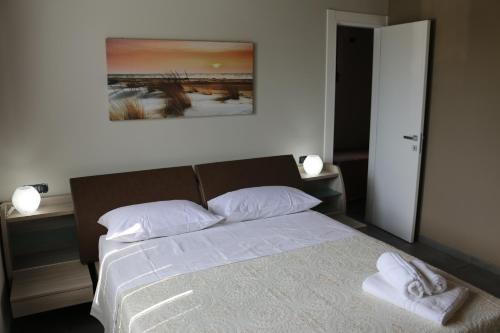 a bedroom with a bed with two towels on it at B&B A CASA DI ZIA LUISA in Venticano