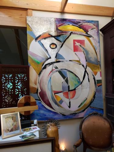 a painting hanging on a wall in a room at Tortuga Inn in Winamac