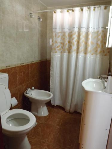 a bathroom with a toilet and a sink at Cabañas San Jose in Potrero de Garay