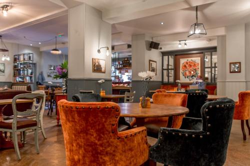 a restaurant with a wooden table and chairs at Orange Tree in Richmond upon Thames