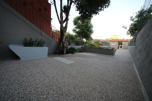 a courtyard with a tree next to a building at Povoa do Mar in Póvoa de Varzim