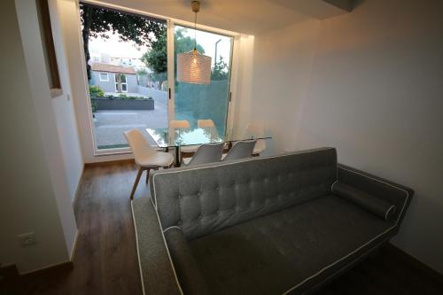 a living room with a couch and a table and a window at Povoa do Mar in Póvoa de Varzim