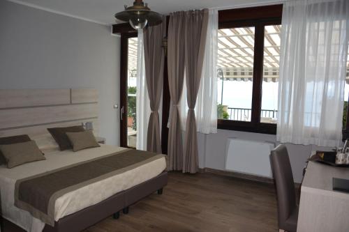 a bedroom with a bed and a large window at Asseu in Sestri Levante