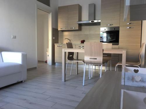a kitchen with a table and chairs in a room at Bed&Beach in Scauri