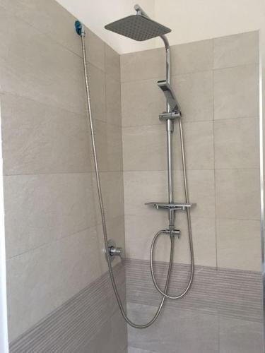 a shower with a shower head in a bathroom at Bed&Beach in Scauri