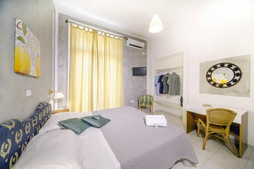 a bedroom with a bed with a table and a desk at Hotel Le Orchidee in Naples