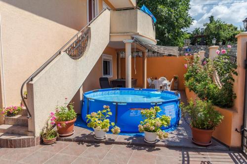 a hot tub on a patio with potted plants at Apartments Vuksanovic in Tivat