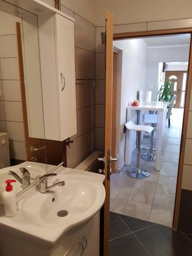 a bathroom with a sink and a mirror at Apartman Anna in Ogulin