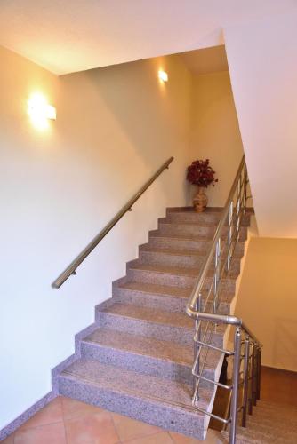 a staircase in a building with a vase of flowers at Lina Hotel in Bansko