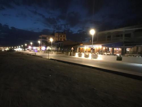 a street lit up at night with street lights at Ca Na Clar in Sa Ràpita