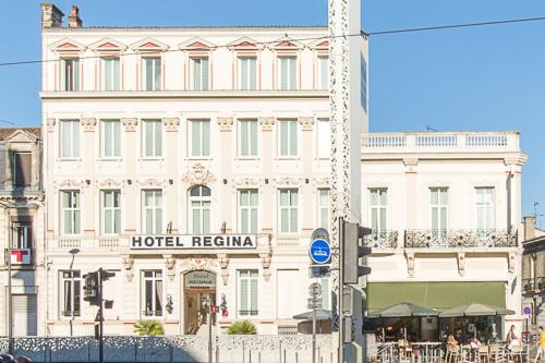 a large white building with a hotel retention sign on it at Citotel Le Regina Bordeaux Gare Saint-Jean in Bordeaux