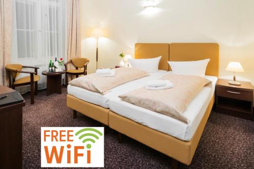 um quarto de hotel com uma cama e um sinal para Wi-Fi gratuito em Upper Room Hotel Kurfürstendamm em Berlim