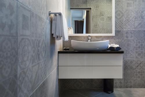 a bathroom with a sink and a mirror at Mirabilis Residence in Zadar