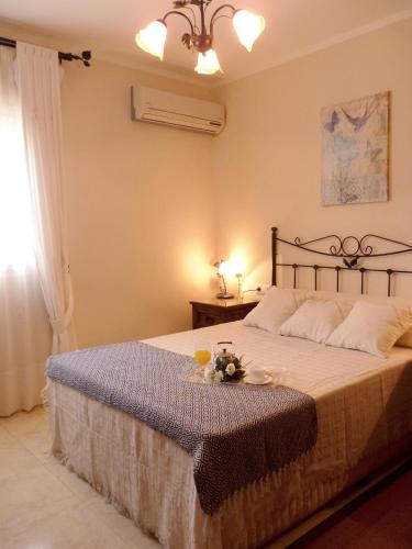 a bedroom with a bed with a tray of food on it at Playa de la Calzada in Sanlúcar de Barrameda