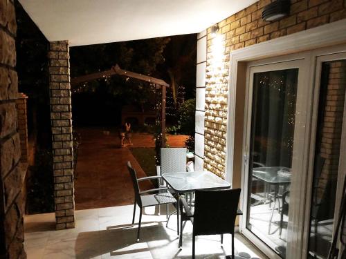 a table and chairs on a patio at night at Alrose in Limenaria