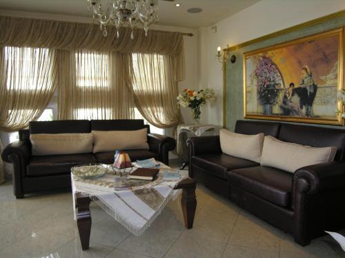 a living room with two couches and a coffee table at Filippos in Nea Moudania