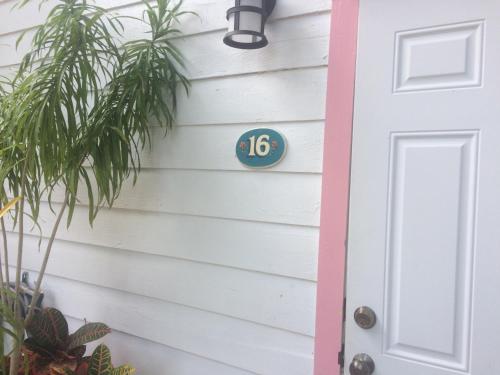 a house number sign on the side of a house at Courtney's Place Historic Cottages & Inns in Key West