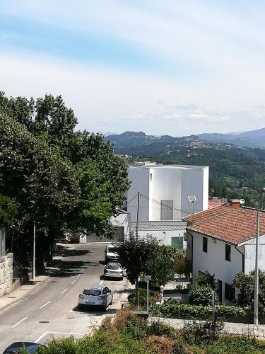 a city street with cars parked in a parking lot at Alojamento de Santa Maria (near Siza Vieira's Church) in Marco de Canaveses