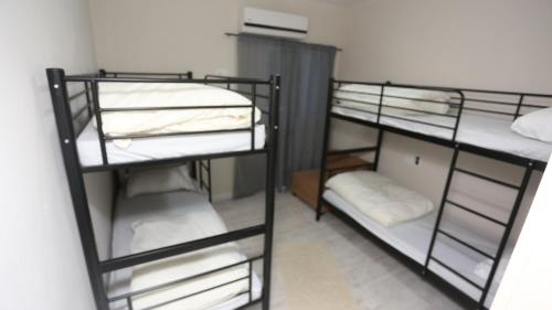 a room with three bunk beds in a room at הקצה- The Edge in Sifsufa