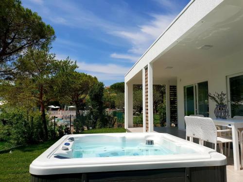 a hot tub on the patio of a house at Villaggio La Pescaccia in San Clemente