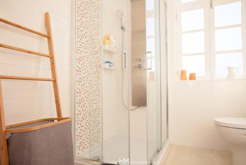 a bathroom with a glass shower with a toilet at Casa da Muralha in Angra do Heroísmo