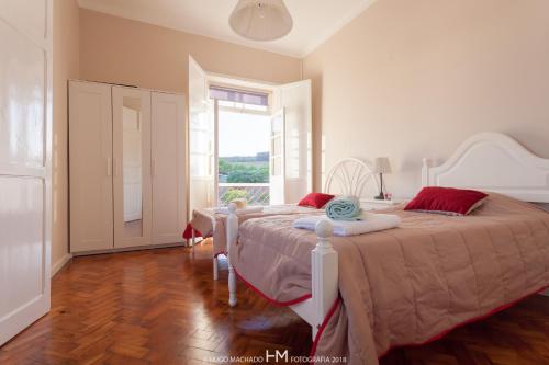 una camera da letto con due letti e una grande finestra di Casa da Muralha ad Angra do Heroísmo