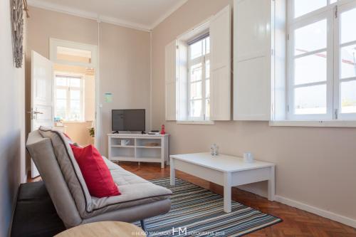 a living room with a couch and a table at Casa da Muralha in Angra do Heroísmo