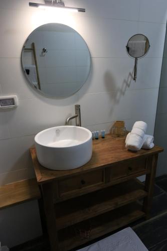 a bathroom with a white sink and a mirror at הקצה- The Edge in Sifsufa