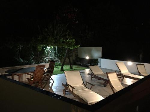 a group of chairs and a table on a patio at night at Bed & Breakfast Spigolatrice in Sapri