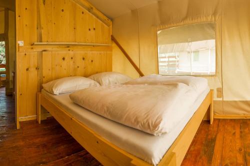 a large bed in a room with a window at SunFlower Camping Savudrija in Savudrija
