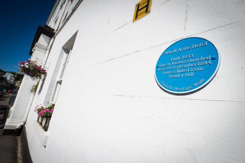 a blue sign on the side of a building at Atholl Arms Hotel Dunkeld in Dunkeld