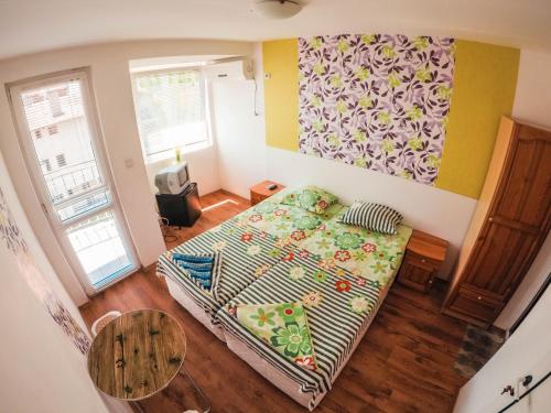 a small room with a bed and a table at Guest House Gabriel in Sozopol