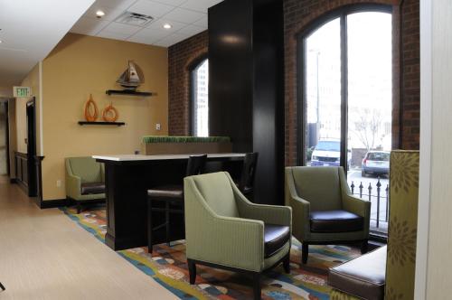 a waiting area in a hospital with chairs and a bar at Days Inn by Wyndham Baltimore Inner Harbor in Baltimore