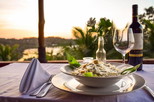 a table with a bowl of pasta and a bottle of wine at The Resort at Marble Hill in Diamond Rock