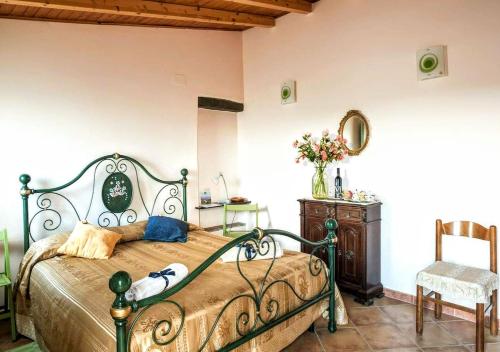 a bedroom with a bed and a table and a chair at Vasari in Santa Lucia del Mela