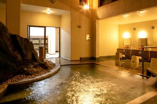a pool of water in the middle of a room at Honjin in Izunokuni