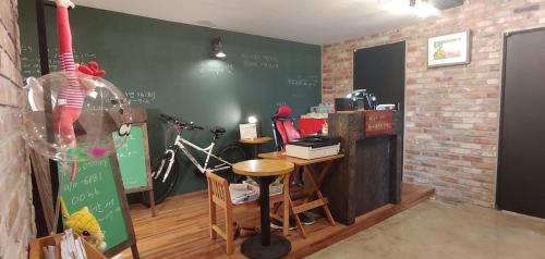 a classroom with a chalkboard and a table and a desk at White Windmill Guesthouse in Mokpo