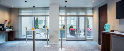 a lobby with two tables with vases on them at Hyatt Centric Times Square New York in New York
