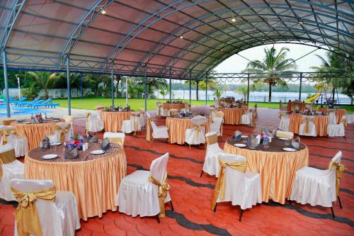 a group of tables and chairs in a tent at Renai Blue Waters Cherai in Cherai Beach