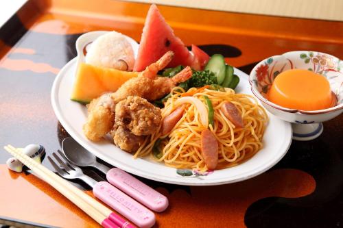 a plate of food with shrimp and pasta on a table at Tsukasaya Ryokan in Tsuruoka