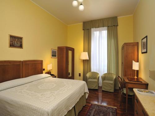 Tempat tidur dalam kamar di Albergo San Domenico