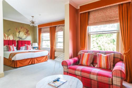 a hotel room with a bed and a couch at The Ayrlington Guesthouse in Bath