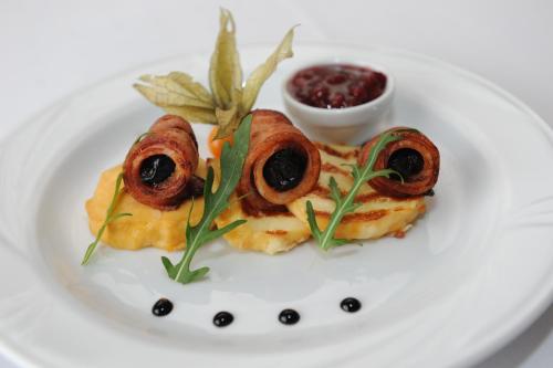 a white plate with some food on it at Hotel Vis a Vis Łańcut in Łańcut